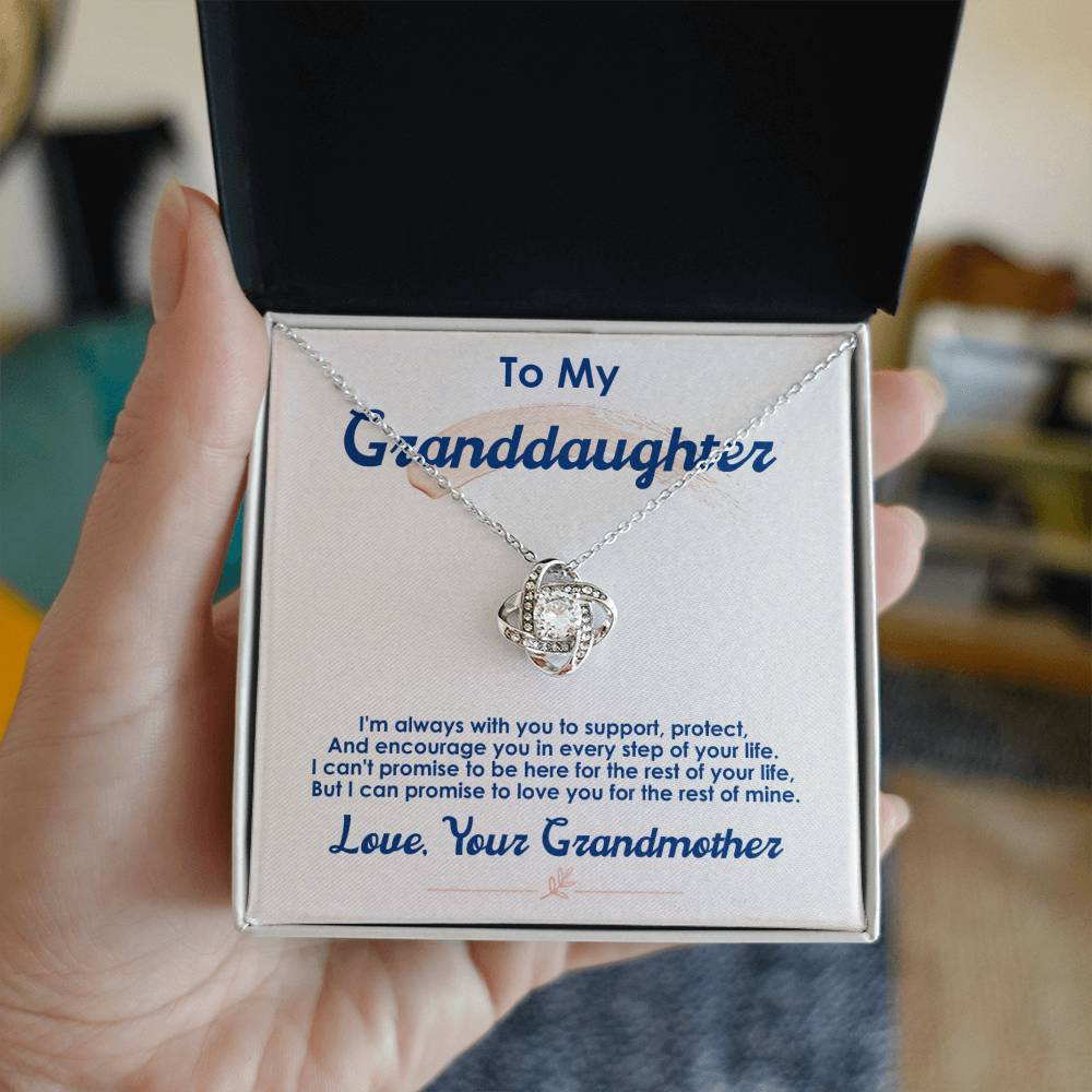 Grandmother-to-granddaughter gift—18k gold love knot pendant on card that says “I’m always with you,” luxury keepsake box.
