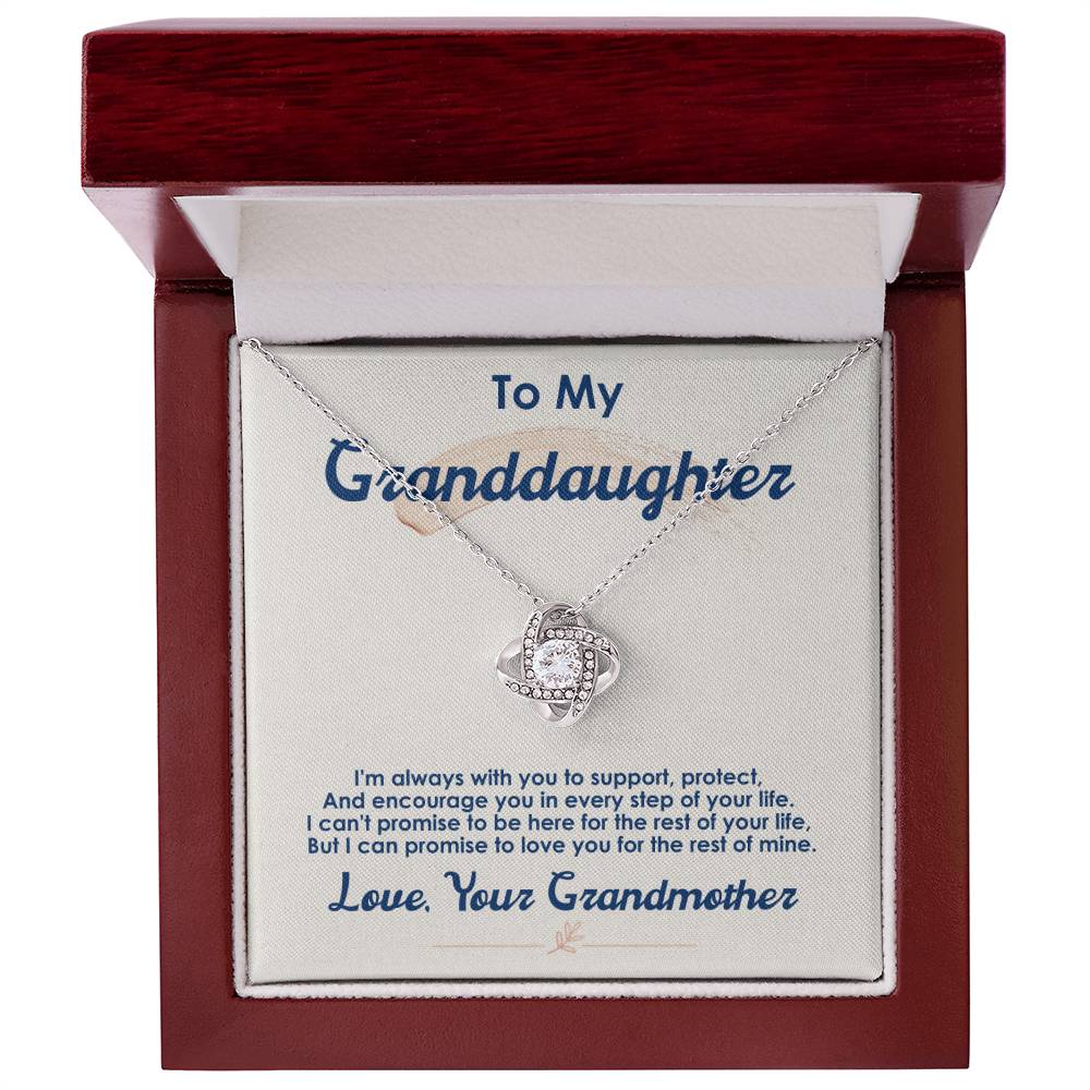 Heartfelt jewelry gift: gold love-knot pendant, motivational support card from Grandma, presented in light-up wooden display box.